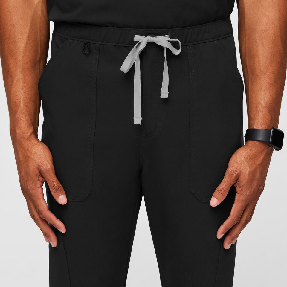 Jogging gris foncé, ceinture élastique, poches zip